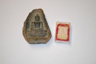 An ancient Asian pottery fragment of a seated Budd