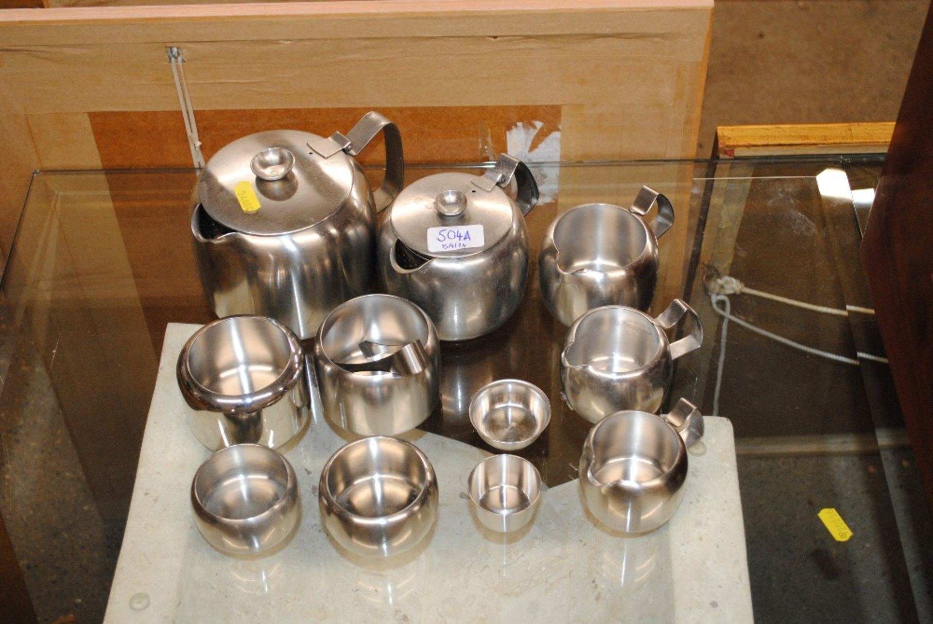 A quantity of stainless steel teaware