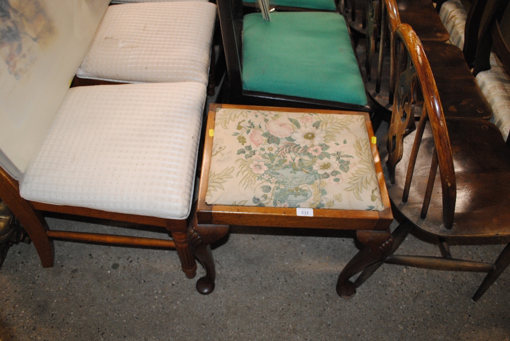 An upholstered dressing table stool and a pair of