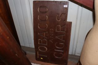 A wooden "Tobacco and Cigars" advertising sign