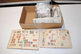 A box containing two old stamp albums, various loo