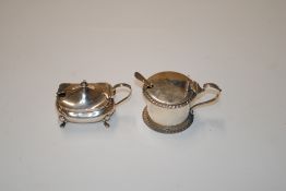 Two silver mustard pots, one lacking glass liner,