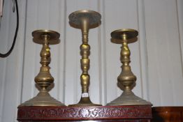 A pair of brass baluster candle stands and a large