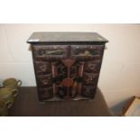 An Oriental lacquered trinket cabinet