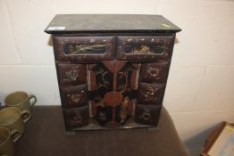 An Oriental lacquered trinket cabinet