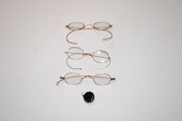Three pairs of yellow metal spectacles, one AF; and a monocle holder