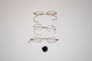 Three pairs of yellow metal spectacles, one AF; and a monocle holder