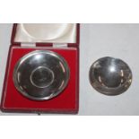 A circular silver dish inset with 1965 Churchill C