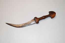 A curved dagger with wooden handle