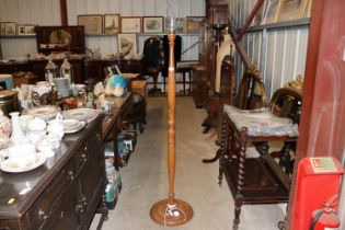 An Oriental carved wooden standard lamp