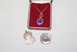 A silver ARP badge; an Australian Forces badge and