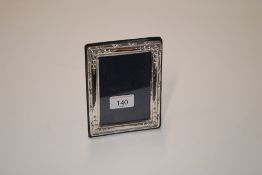 A small silver mounted photo frame with blue plush