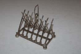A silver plated six division toast rack in the for