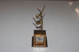 A brass cased clock mounted with Lorenzl style fig