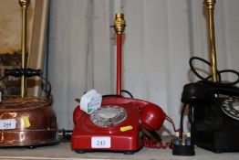 A table lamp in the form of a red vintage dial tel