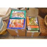 Two boxes of various jigsaw puzzles