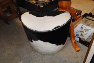 A cow hide rotating stool