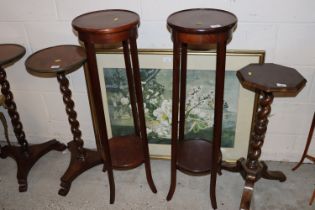 A pair of mahogany two tier jardinière stands