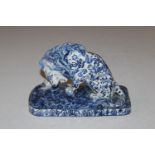 A Faience blue and white study of a lion AF