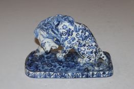 A Faience blue and white study of a lion AF