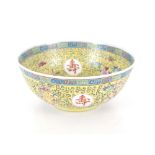 A Chinese yellow ground bowl, profusely decorated