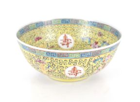 A Chinese yellow ground bowl, profusely decorated