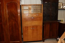 A light oak retro kitchen cabinet, the glazed uppe