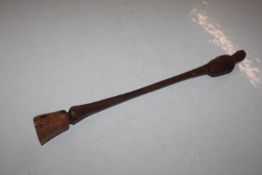 A carved hardwood club in the form of a horses fro