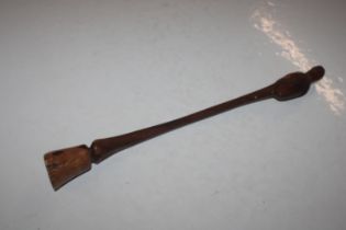 A carved hardwood club in the form of a horses fro