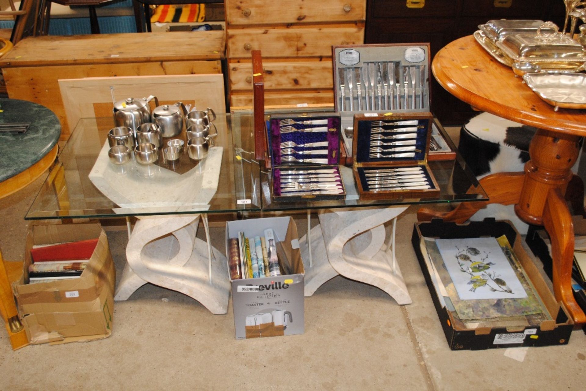 A pair of Travertine glass topped tables