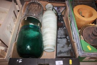 A mirrored stand and various coloured glass vases