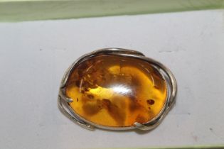 A silver and amber Art Nouveau style brooch