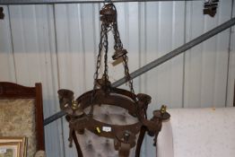 A wrought metal six light chandelier