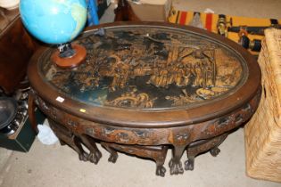 An Oriental nest of tables with relief carved decoration