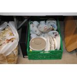 A box of various tea and dinnerware