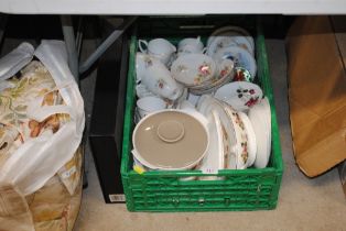 A box of various tea and dinnerware