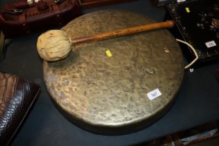 A large bronze dinner gong and beater