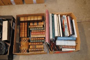 A box of various leather bound books and a leather