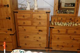 A stripped pine chest of four short and three long