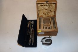 A cased set of geometry instruments and a engraving set