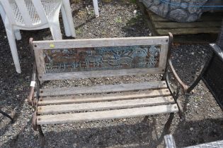 A metal and wooden child's bench