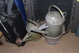 Two galvanized watering cans and a galvanized pail