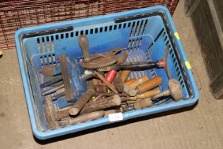A basket of tools to include bench vice