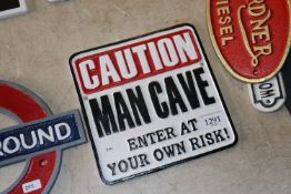 A Caution Man Cave sign (210)