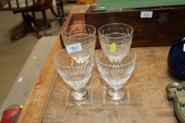 A pair of etched glass square based rummers and a