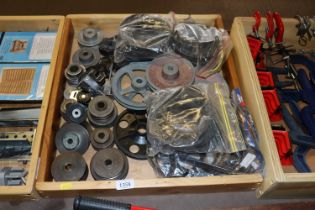 A wooden tray containing various V-belt pulleys an