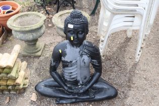 A garden ornament in the form of a Buddha