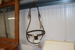 A brass hanging lamp converted to electricity