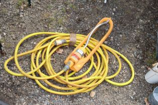 A garden hosepipe and sprinkler