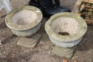 A pair of concrete garden urns, one AF